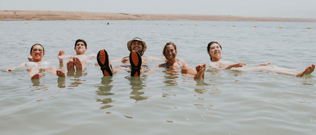 PEOPLE FOLATING AT THE DEAD SEA