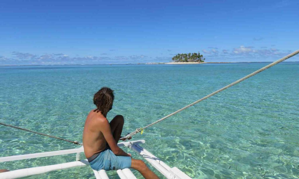Traveler looking out over the ocean in Siargao, Philippines