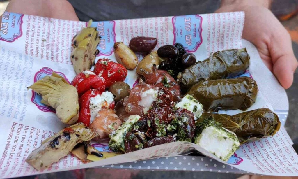Selection of olives, stuffed vegetables and Mediterranean food at a Tel Aviv market