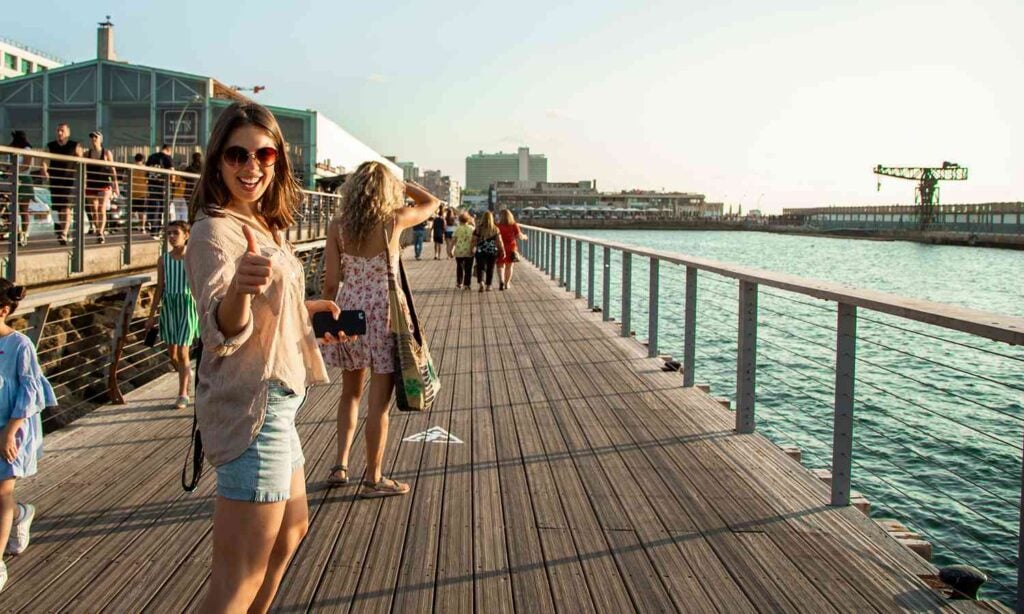 Visitors walking along the waterfront promenade at Tel Aviv Port